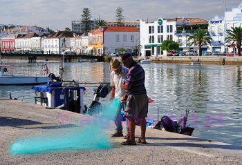 Obrazek z Taviry w południowej Portugalii; rybacy na nabrzeża rybackim nad rzeką Gilao